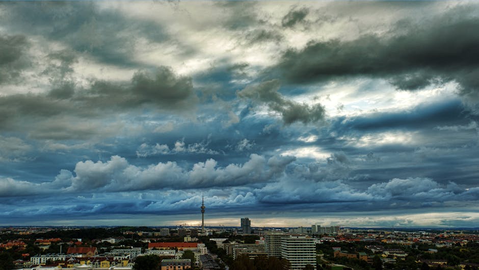 27 Mart Hava Durumu: Antalya 14°C ile En Sıcak, Ankara 7°C ile En Soğuk — A breathtaking view of an urban skyline with dramatic clouds and a distinctive t