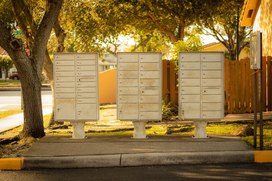 BTK İstenmeyen SMS ve Aramaları Kaynağında Engelleyecek Sistem Devreye Aldı — Three cluster mailboxes under trees in a residential area of Florida, USA, on a 
