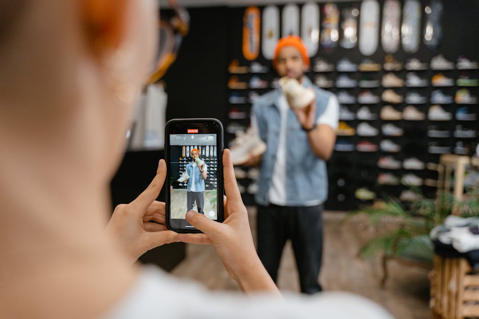 BİM'den Redmi 15C 5G Telefon Şoku: Piyasa Fiyatının Altında Satacak — Person filming a shoe shopping experience in a trendy store using a smartphone.