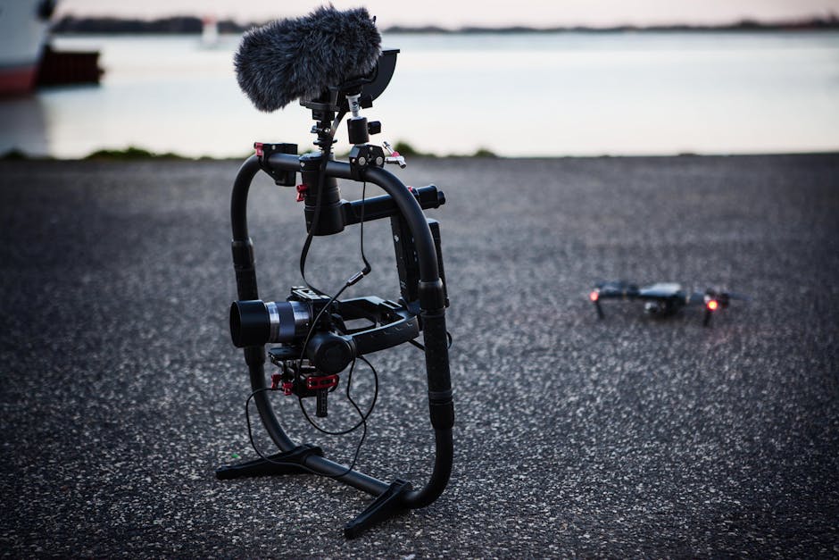 DJI Avata 360'ın 8K Video İşleme Sistemi: Yapay Zeka Destekli Görüntü Stabilizasyonu — High-end camera gear on pavement by the water, showcasing professional filmmakin