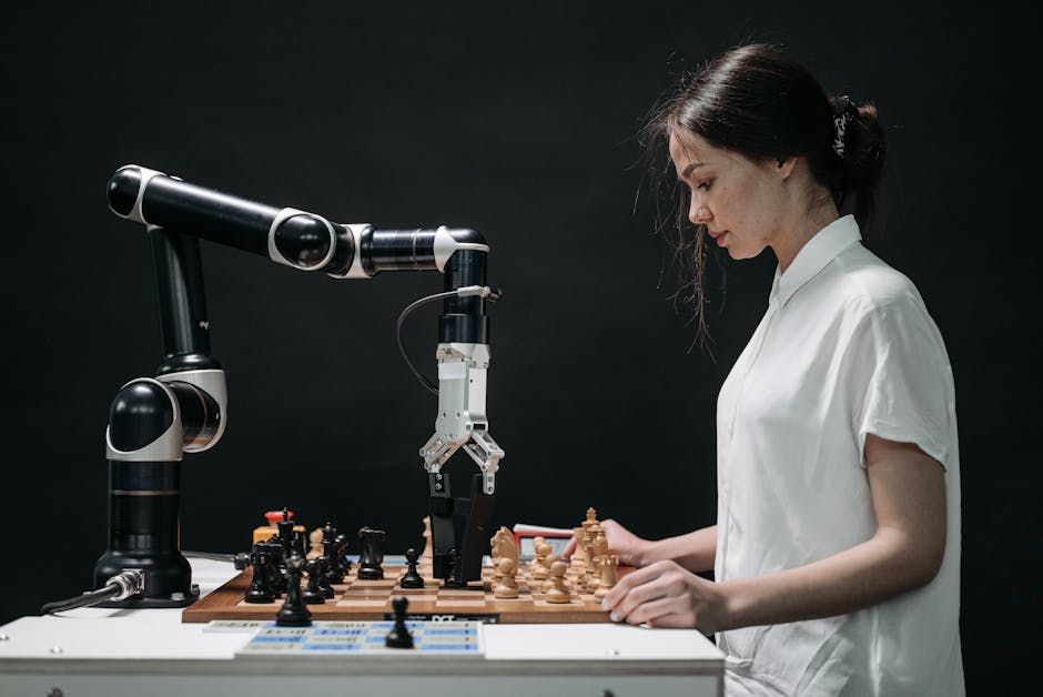 TBMM Oyun Yasası Komisyonda: Yapay Zeka Sektörüne Etkiler — A robot and woman engage in chess, showcasing technology and strategic thinking.
