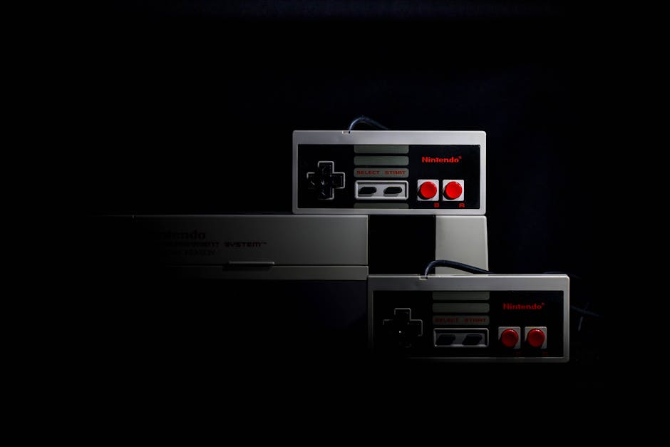 Retro Gaming Hub Platformu 1980'ler Konsol Koleksiyonunu Genişletiyor — Retro gaming controllers from the Nintendo Entertainment System in low-key light